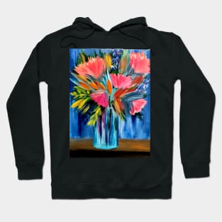 A lovely boutique of abstract vibrant bright colorful  flowers in a tall turquoise glass vase Hoodie